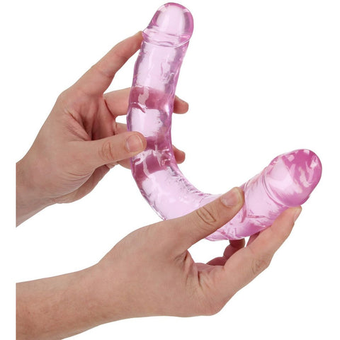 Dildo Duplo Realista RealRock Rosa 34cm posicionado elegantemente, simbolizando o prazer e a satisfação do corpo feminino.