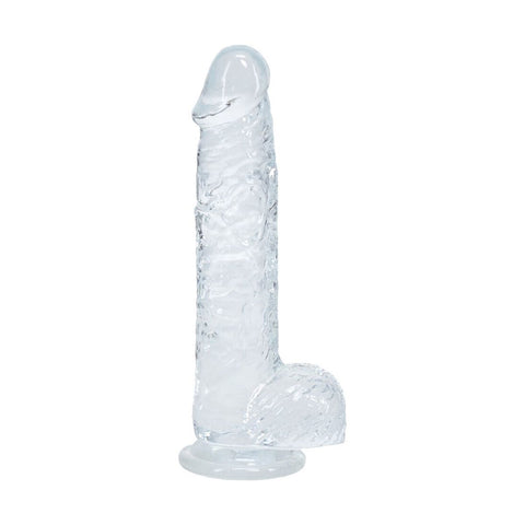 Dildo RealRock Transparente Realista com Testículos - apresentação do produto em ambiente íntimo, ampliando a coleção de brinquedos sexuais.